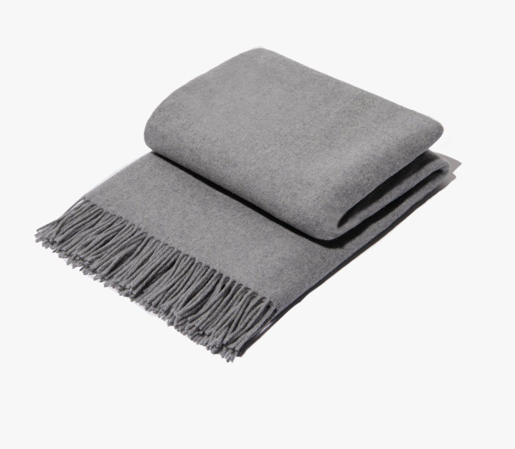 folded grey wool fringe throw