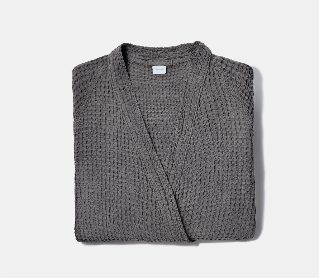 Folded Charcoal Grey Honeycomb Bathrobe with white background.