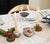 dinnerware and marble candle holder with a candle and a marble salt bowl