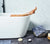 woman in a luxury white bath tub