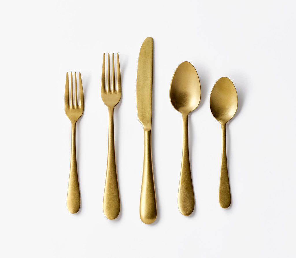 Brushed Gold Flatware Setting on white background.