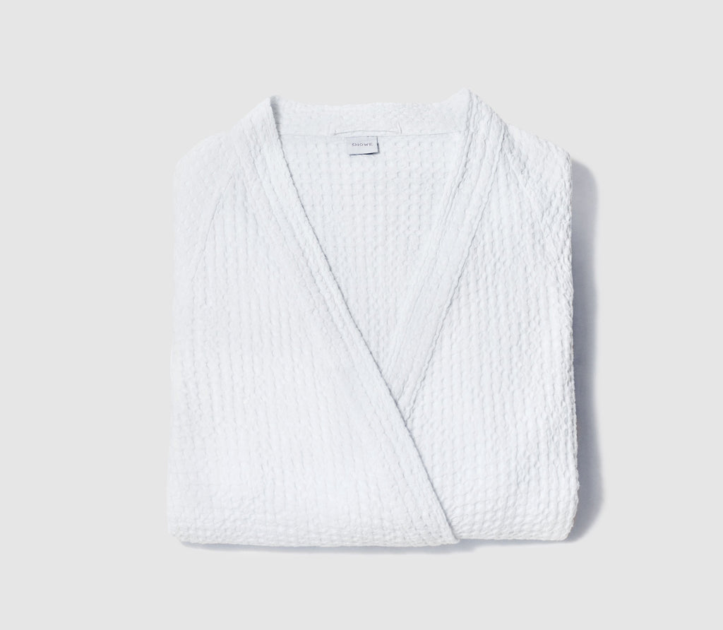 Folded Essential White Honeycomb Bathrobe with white background.