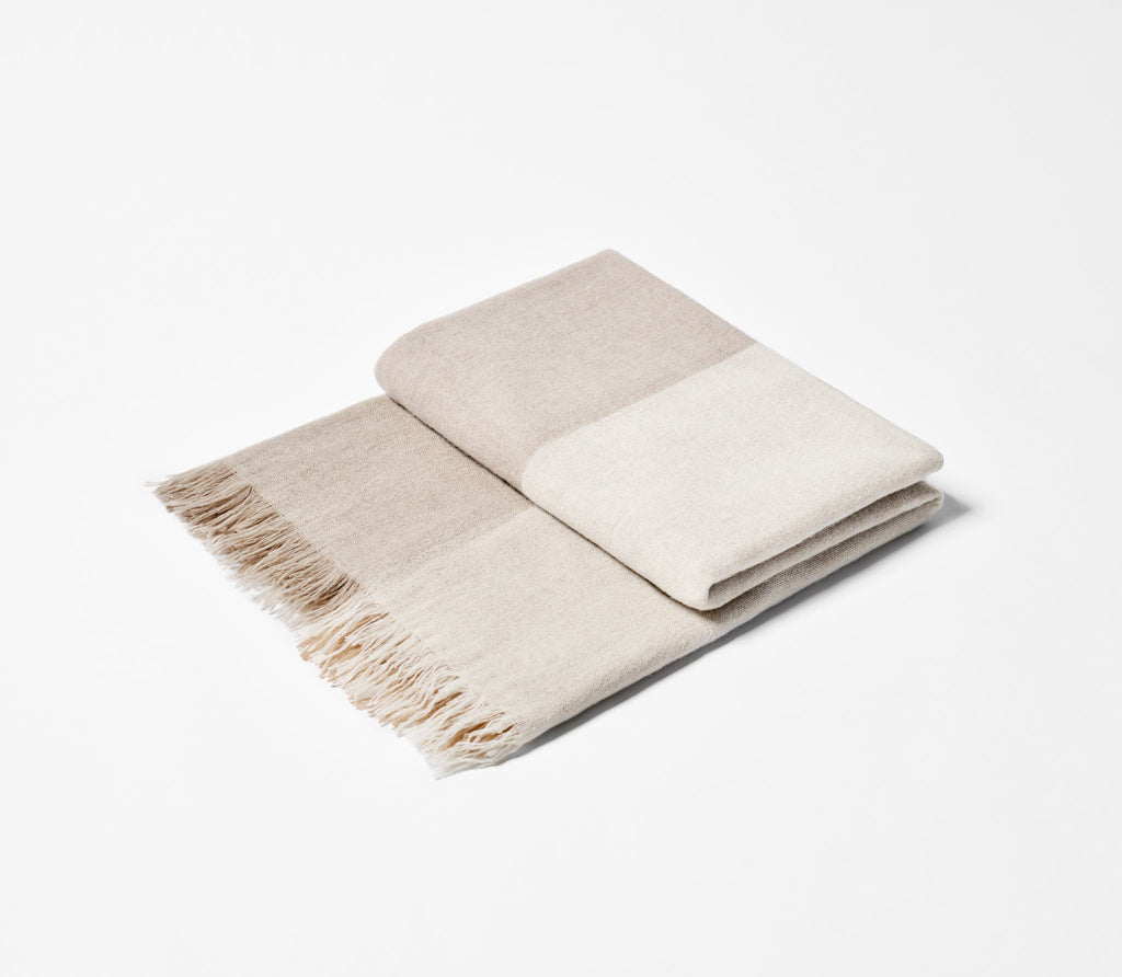 Folded Natural Checked Throw showing fringed edge.