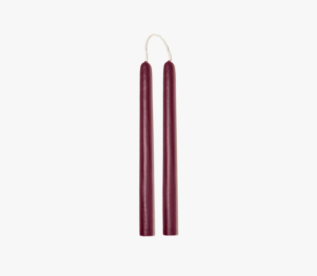 two maroon colored candles