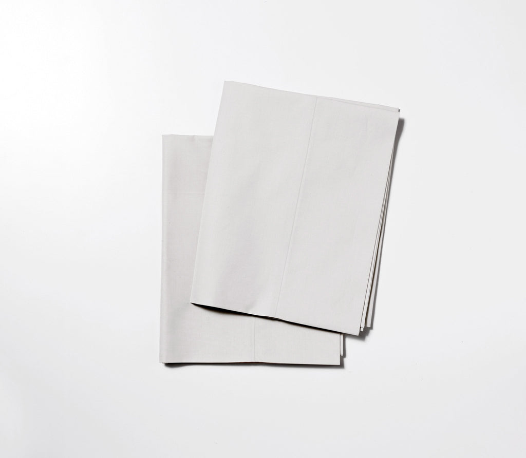 two folded grey sateen pillowcase