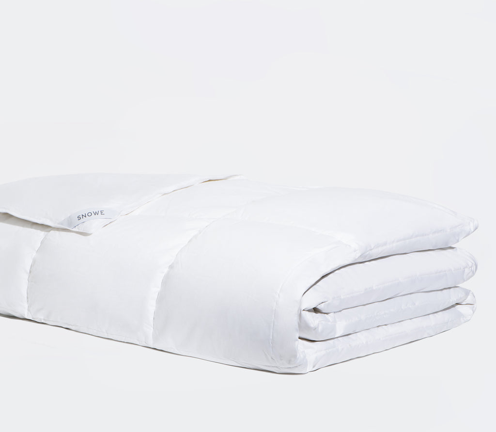 Folded white premium Down Comforter with white background.